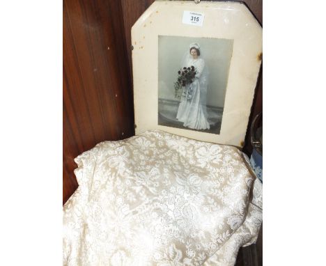 AN EARLY TO MID 20TH CENTURY VINTAGE WEDDING DRESS, complete with original photograph of the bride in period frame, the dress