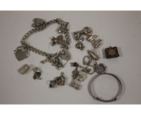 A SILVER CHARM BRACELET TOGETHER WITH A QUANTITY OF LOOSE CHARMS AND A SILVER BANGLE 