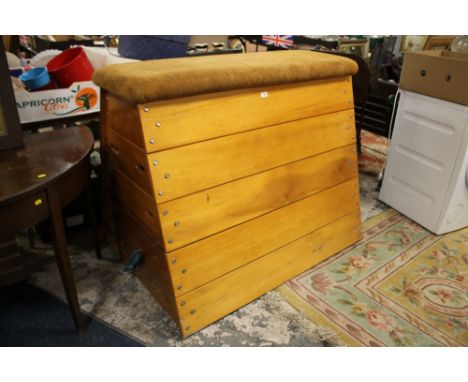 A VINTAGE WOODEN SECTIONAL POMMEL HORSE WITH UPHOLSTERED TOP