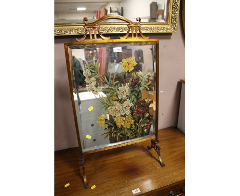 A BRASS MIRRORED FIRESCREEN WITH FLORAL PAINTED DETAIL