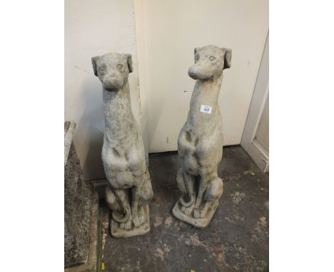 A PAIR OF SITTING STONE GREYHOUND FIGURES