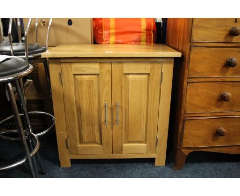 A MODERN LIGHT OAK TWO DOOR CABINET A/F