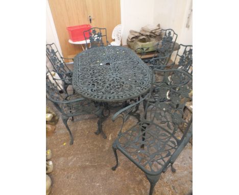 A CAST METAL GREEN GARDEN BENCH WITH SIX CHAIRS