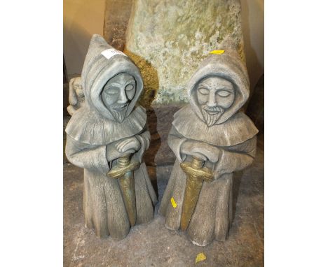 A PAIR OF STONE GARDEN ORNAMENT ROBED WIZARD STYLE FIGURES WITH SWORD