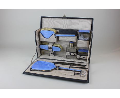 An Edward VIII Art Deco silver travelling dressing set with blue enamel decoration comprised of eleven items including a hand