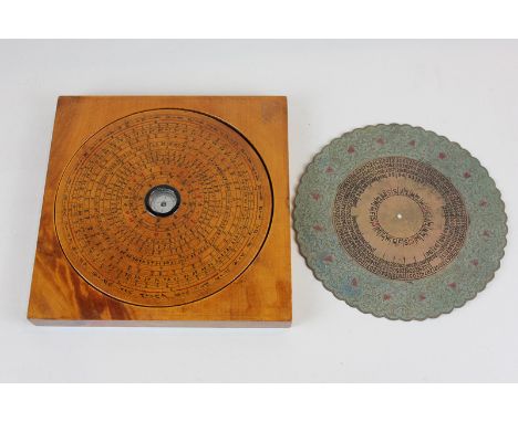 A Chinese circular wooden compass, 16cm, in fitted square case, 19cm, and metal disc calendar, (SPM)