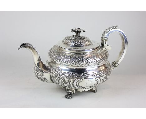 A George IV Irish silver teapot with embossed floral body and flower bud finial, maker James Le Bas, Dublin 1825, 27oz, (a/f 