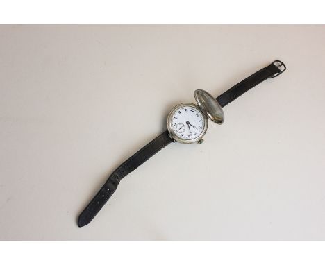 An early silver wristwatch, white enamel, unsigned dial, the movement by Unicorn, screw down case back and hinged cover crest