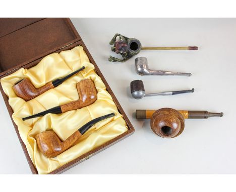An unusual pipe with the bowl in the shape of the planet Saturn, a cased set of three pipes, and three other various pipes, (