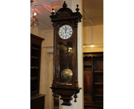 A Vienna wall clock in walnut case, with white enamel dial with subsidiary seconds dial, the gong striking twin height driven
