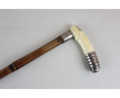 A early 20th century ivory and unmarked silver handled walking stick