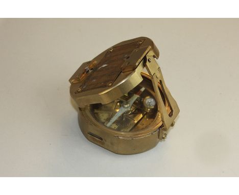 A brass cased compass with internal spirit level and mirrored sight, (SPM)