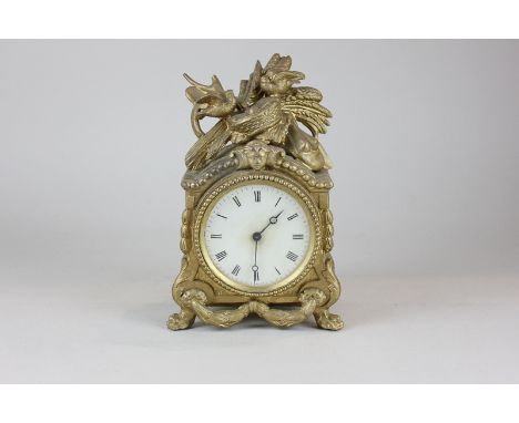 A French Brevette gilt spelter mantel clock decorated with a harvest scene, with circular white enamel dial and Roman numeral