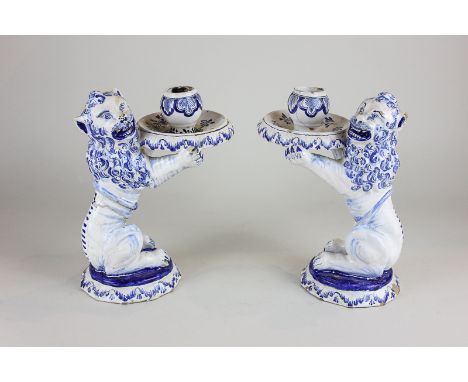 A pair of 17th/18th century Delftware candle holders modelled as lions by Aelbregt Keizer (AK mark to base) (a/f), 21cm high