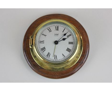 A Sestrel porthole alarm clock with Roman numerals on silverised face