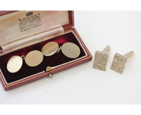 A pair of 9ct gold cuff-links engine turned and plain ovals, and a pair of 9ct gold textured rectangular cuff-links, 18.9g
