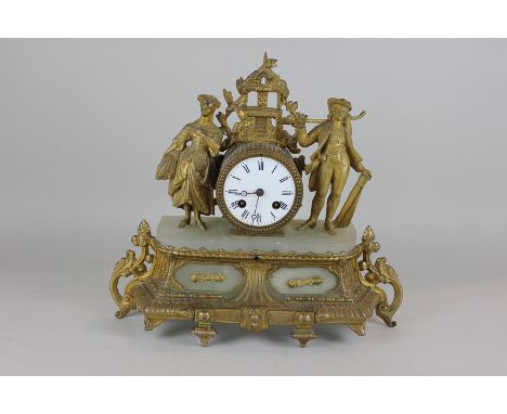 An ormolu and onyx mantel clock decorated with figures off harvesters, white enamel circular dial with Roman numerals, the ei