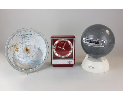 A radio in the form of the moon, a red plastic mantle clock and a planisphere dish (a/f), (SPM)