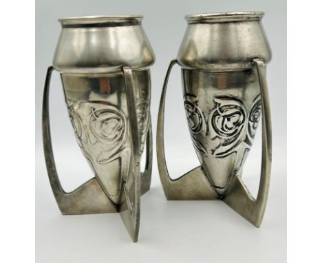 Archibald Knox [1864-1933] for liberty &amp; Co, A pair of Tudric Pewter bomb pattern vases, of tapper form with three angula