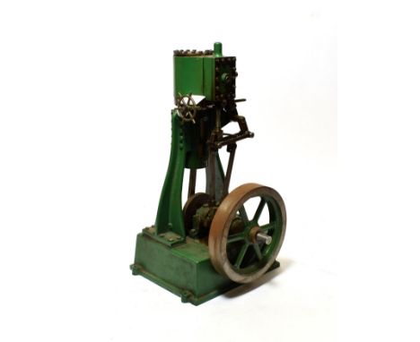 Stationary Upright Engine with single cylinder and flywheel on heavy cast base, with indistinct marking to base 14 1/2'' 37cm