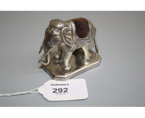 An Indian white metal novelty pin cushion, in the form of an elephant on a rectangular base with canted corners, (unmarked), 