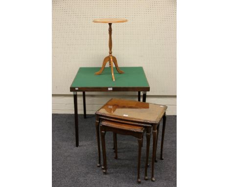 An Edwardian bridge table with baize lined top, on folding supports, a nest of mahogany occasional tables and a golden oak tr