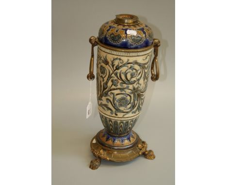 A late 19th century Doulton Lambeth paraffin lamp base, the associated reservoir and gilt metal mounted cylindrical tapering 