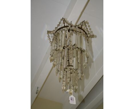 A late 19th century ceiling light of three graduated tiers suspending swags, icicle and faceted lustre drops. 60cm