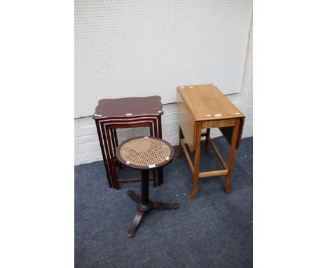 An early 20th century light oak Pembroke table, a nesting set of three mahogany veneered occasional tables and an adjustable 