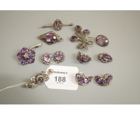 An Arts and Crafts silver and amethyst brooch, in the manner of Bernard Instone, the lozenge-shaped plaque with central oval 