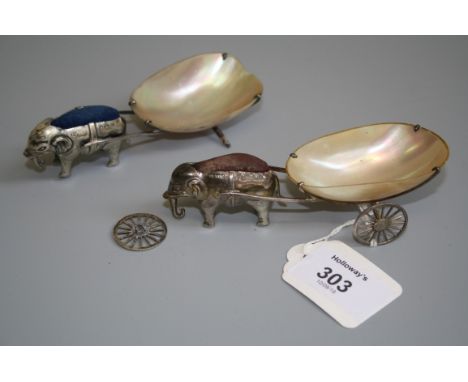 An early 20th century silver novelty pin cushion and pin dish, in the form of an elephant pulling a polished mussel shell car