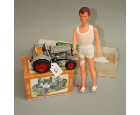 A boxed Gégé Jacky celluloid doll, together with a near mint Kovap 1:25 scale tin plate tractor, also boxed