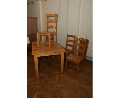 A Golden oak extending dining table with square tapering legs, 139cm long (closed), and four ladder back chairs