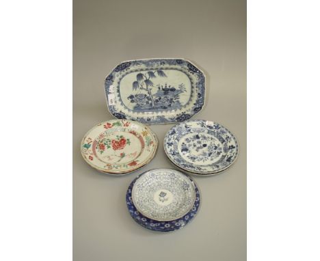 A near pair of 18th century Chinese porcelain plates, blue and white decorated with flowers and trophies, a famille rose porc