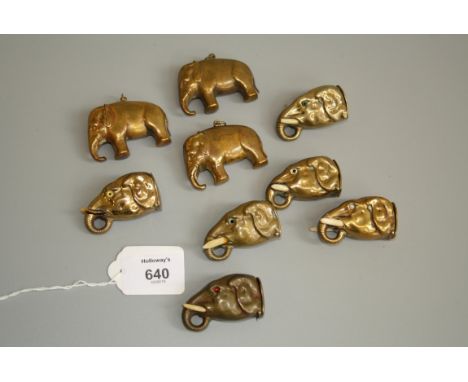 A collection of nine vintage brass novelty vesta cases, in the form of elephant heads with tusk and inset eyes