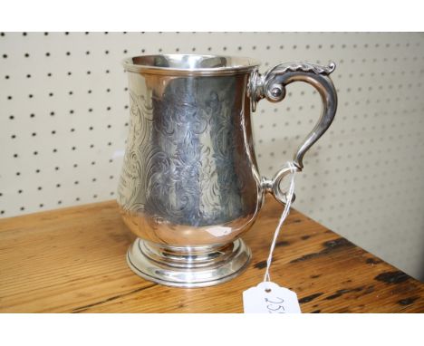 R H , a Victorian silver baluster form tankard with leaf capped scrolled handle, floral chasing and presentation inscription,