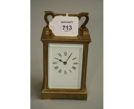 A mid 20th century brass carriage timepiece with eight day movement and enamel Roman dial. 15.5cm (handle up)