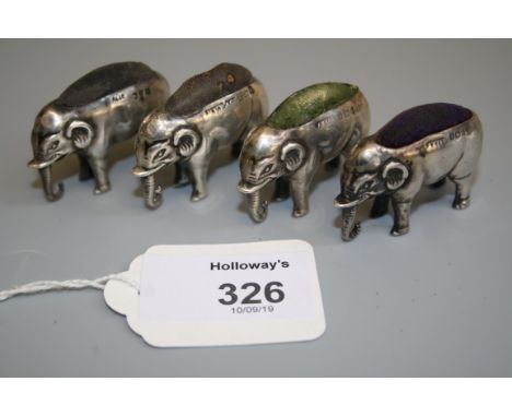 An Edwardian silver novelty pin cushion, in the form of an elephant, Birmingham 1907, together with three similar items (4)