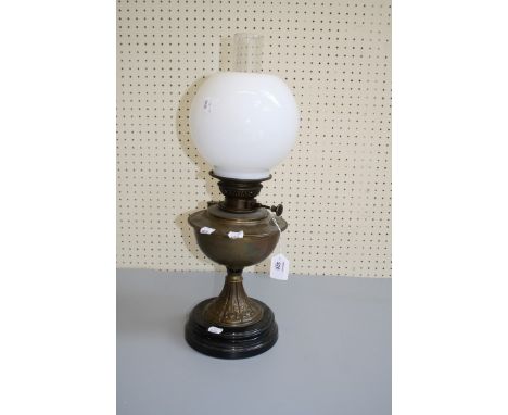 A Victorian brass oil lamp, with white globe diffuser and through type burner, 56cm high