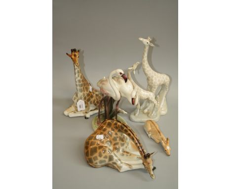 Two Russian ceramic giraffes, a sleeping fawn, a Spanish porcelain giraffe group and an Australian group of flamingo