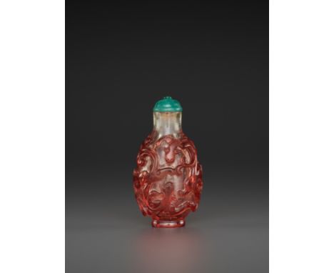 A RUBY-RED OVERLAY TRANSPARENT GLASS ‘CHILONG’ SNUFF BOTTLE, QING DYNASTYChina, 1760-1840. Carved in relief through the trans