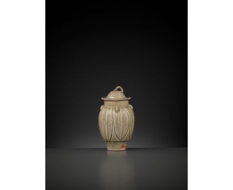 A YUE ‘LOTUS’ JAR AND COVER, FIVE DYNASTIESChina, 907-960. The ovoid body rising from a tall and slightly tapered ring foot, 