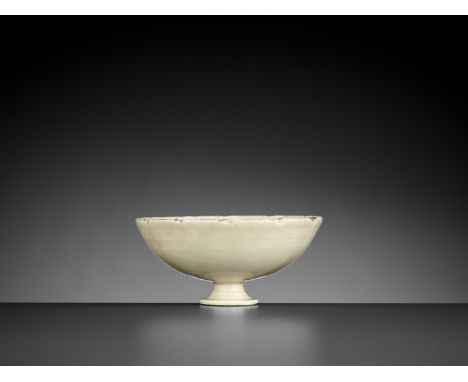 A DINGYAO ‘LOTUS’ STEM CUP, NORTHERN SONG DYNASTYChina, 960-1127. With rounded sides rising from a short splayed stem to a lo