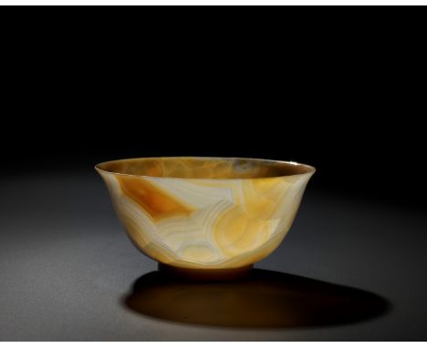 A TRANSLUCENT BANDED AGATE BOWL, QING DYNASTYChina, 18th-19th century. The deep rounded sides rising from a straight ring foo