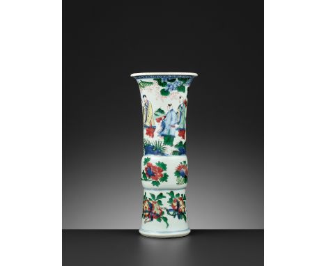 A WUCAI ‘LU XING’ BEAKER VASE, TRANSITIONAL PERIODChina, mid-17th century. The slightly spreading foot rising to a bulbous mi