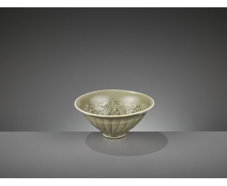 A SMALL YAOZHOU CELADON-GLAZED ‘CHRYSANTHEMUM’ BOWL, NORTHERN SONGChina, 960-1279. With a short foot and gently flaring rim, 