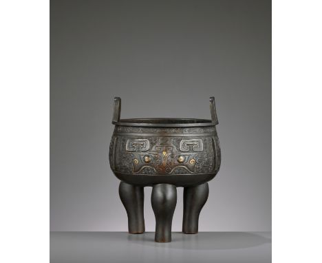A PARCEL-GILT ARCHAISTIC BRONZE TRIPOD CENSER, MINGChina, 1368-1644. The large incense burner of compressed globular form wit