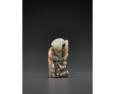 A PALE CELADON, GRAY AND RUSSET JADE FIGURE OF DONGFANG SHUO, QING DYNASTYChina, 18th-19th century. The immortal carved stand