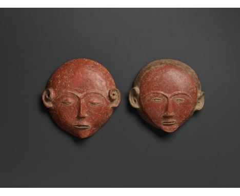 A PAIR OF CERAMIC ANCESTRAL MASKSSoutheast Asia, 19th century. The masks, probably depicting a man and a woman, low-fired and