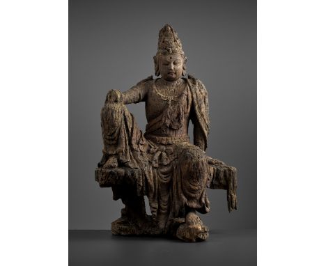 A LARGE AND MASSIVE WOOD STATUE OF GUANYIN, MING DYNASTYChina, 1368-1644. Seated in rajalalitasana on a naturalistically carv